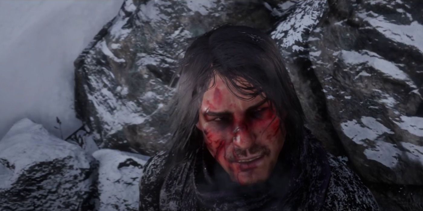 John Marston trapped on a snowy cliff after being attacked by wolves in Red Dead Redemption 2