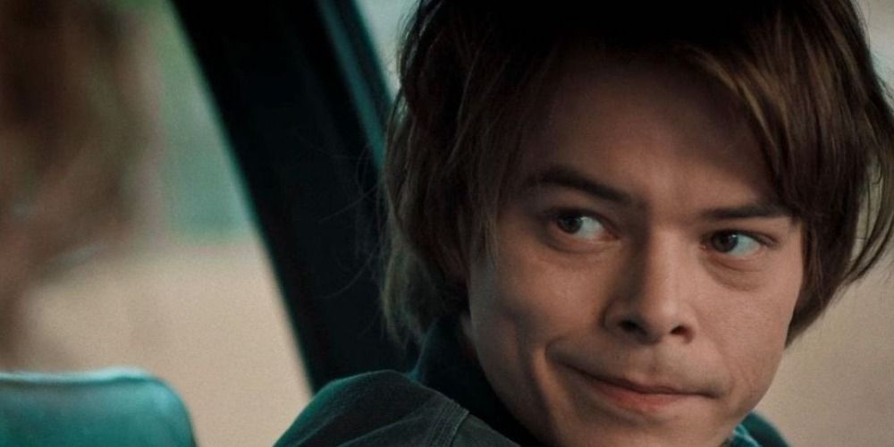 Jonathan Byers from Stranger Things smiles at Nancy in the car