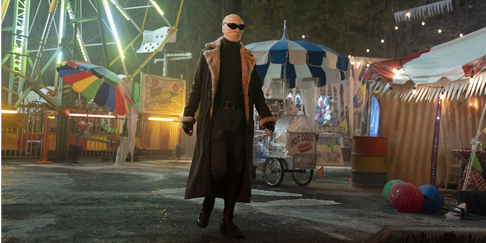 Negative Man stands in a carnival in Doom Patrol.