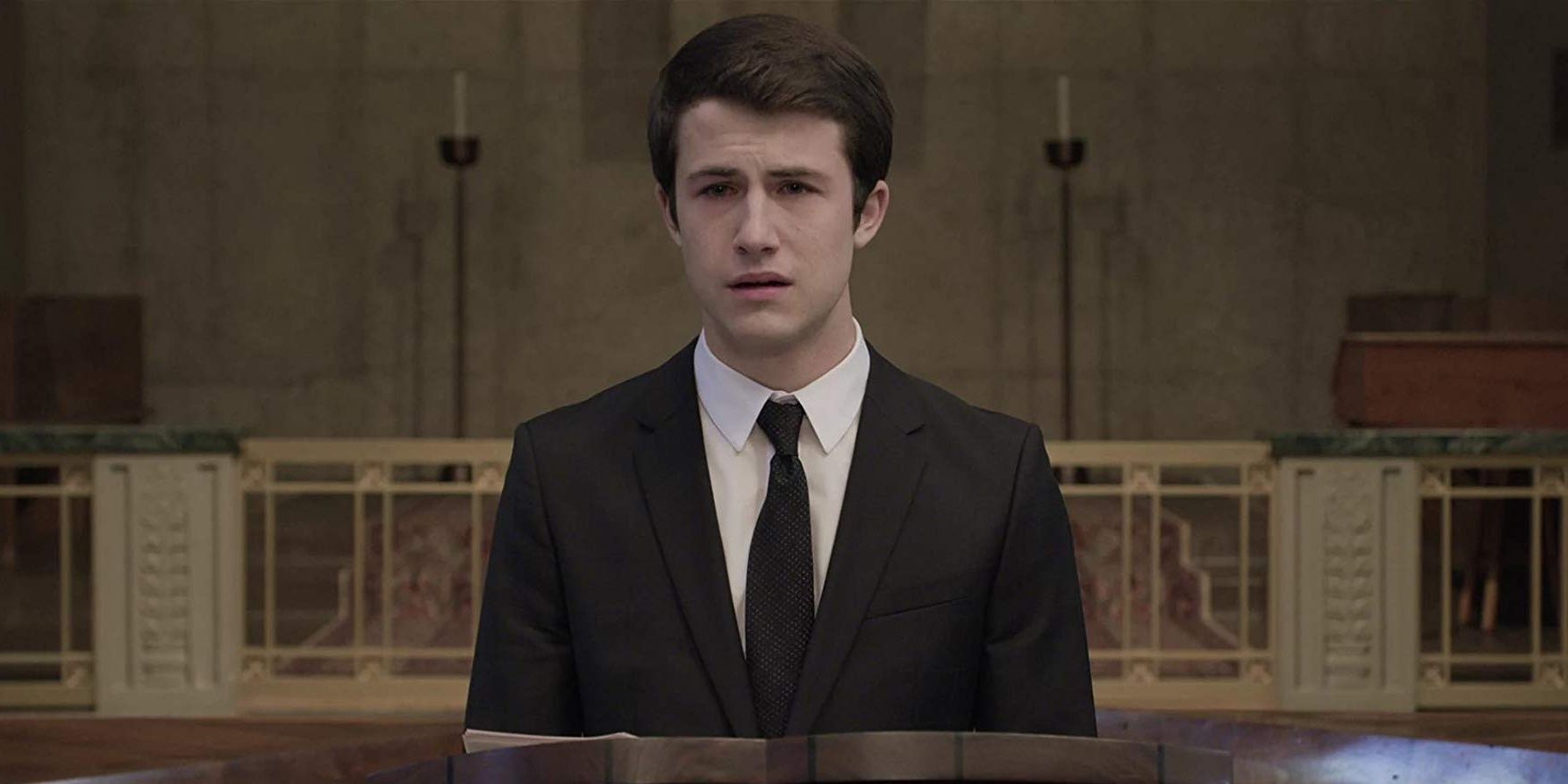 Clay looking sad while speaking at a funeral in 13 Reasons Why