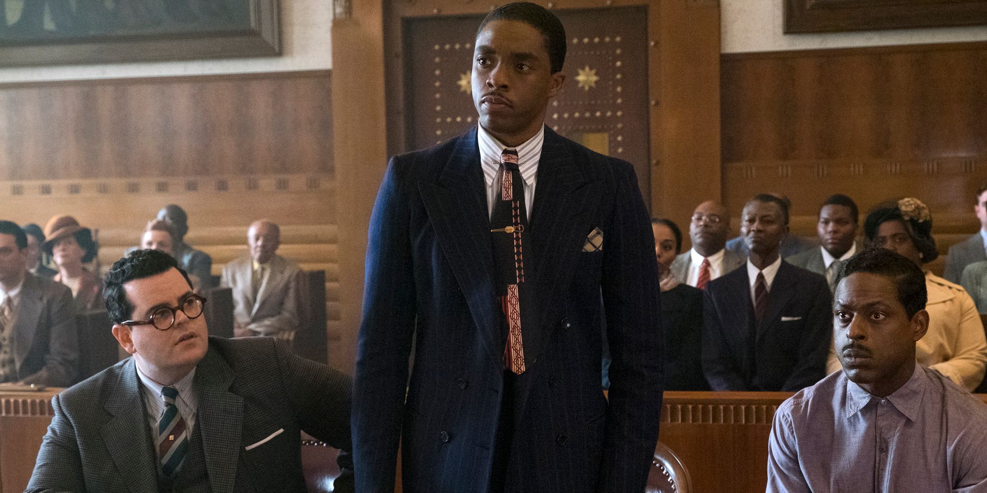 Chadwick Boseman standing up in court in Marshall (2017)