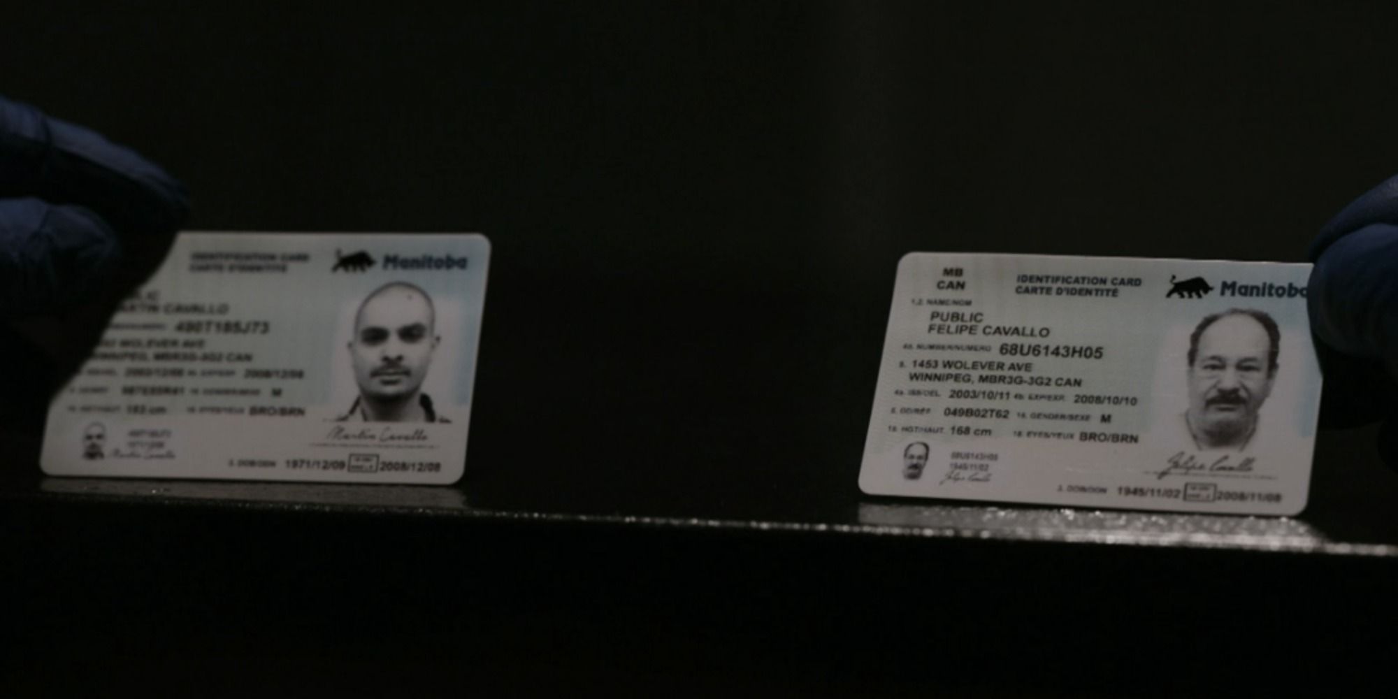 Mike holding Nacho and Manuel Varga's fake IDs in Better Call Saul.
