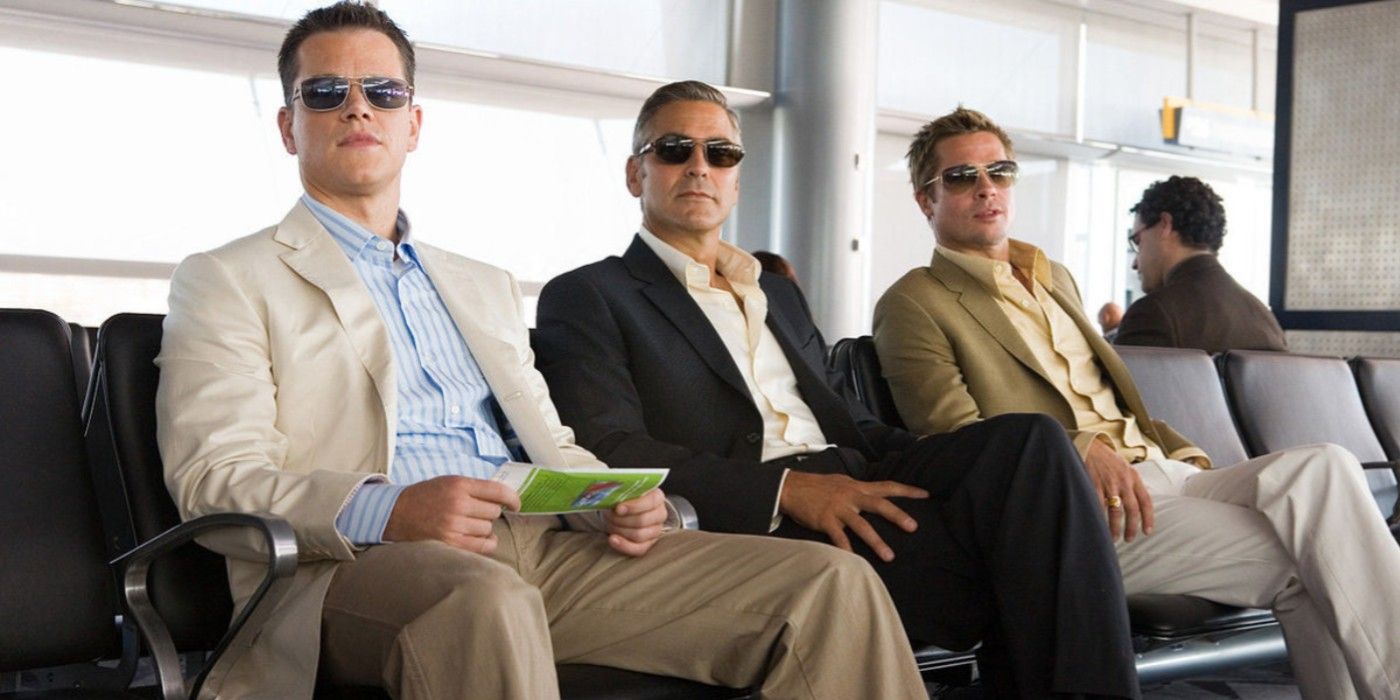 Matt Damon, George Clooney, and Brad Pitt sitting in an airport in Ocean's Thirteen.