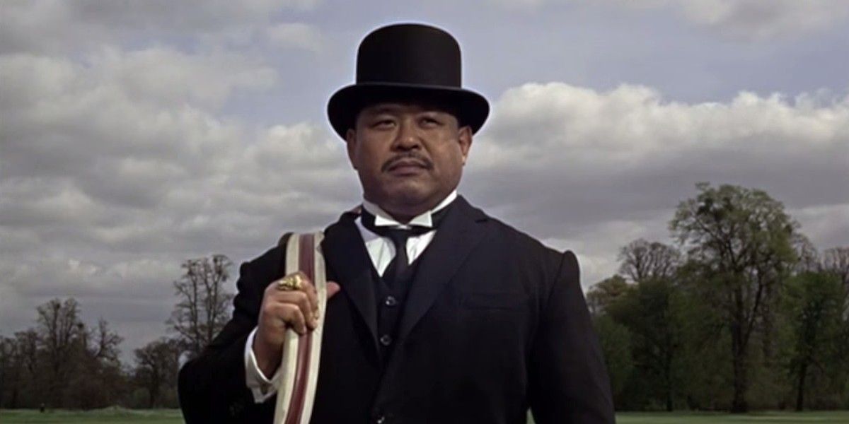 Oddjob carries his boss Goldfinger's bag in Goldfinger.