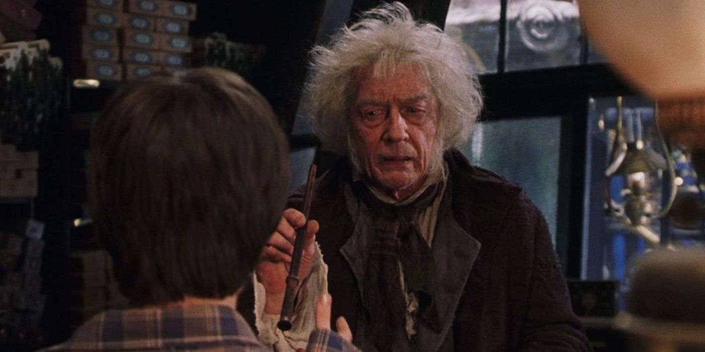 Ollivander with Harry Potter handing him a wand in The Sorcerer's Stone