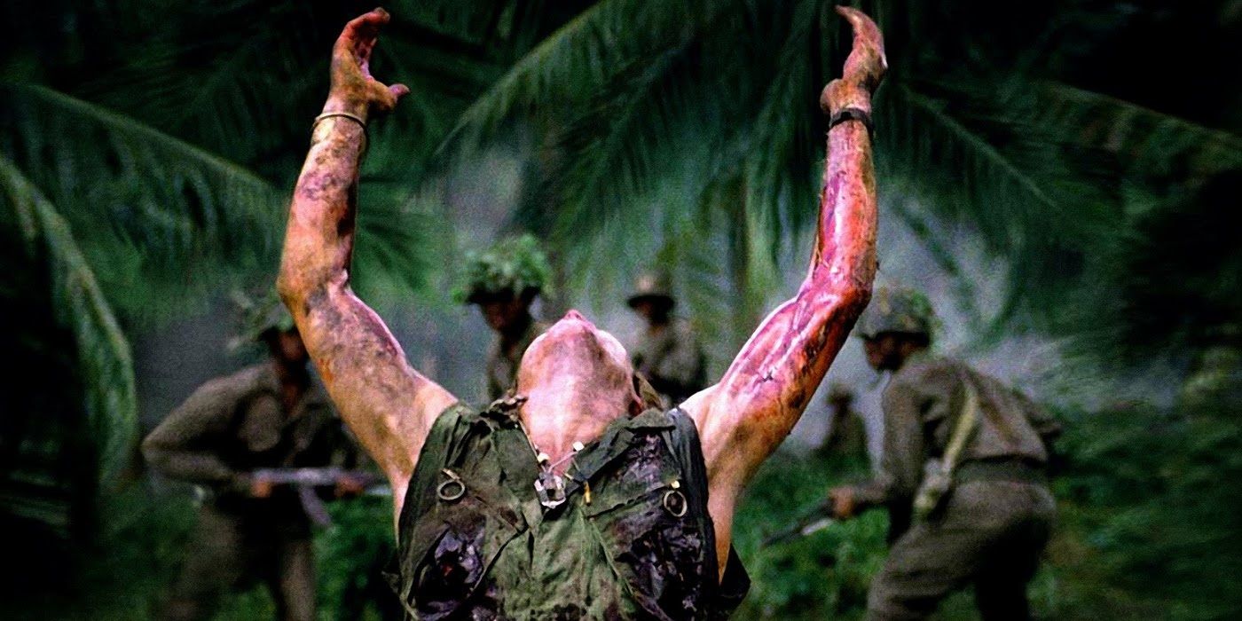 Willem Defoe with is arms up in Platoon.