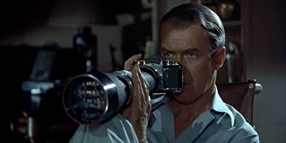 James Stewart looking through a camera lens in Rear Window