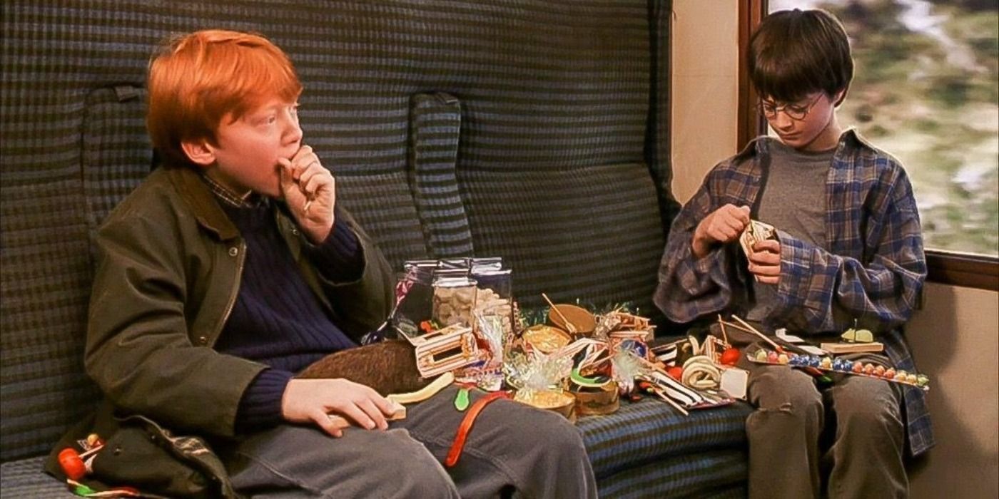 Ron and Harry eating cakes, pastries and chocolate in the carriage of the Hogwarts Express