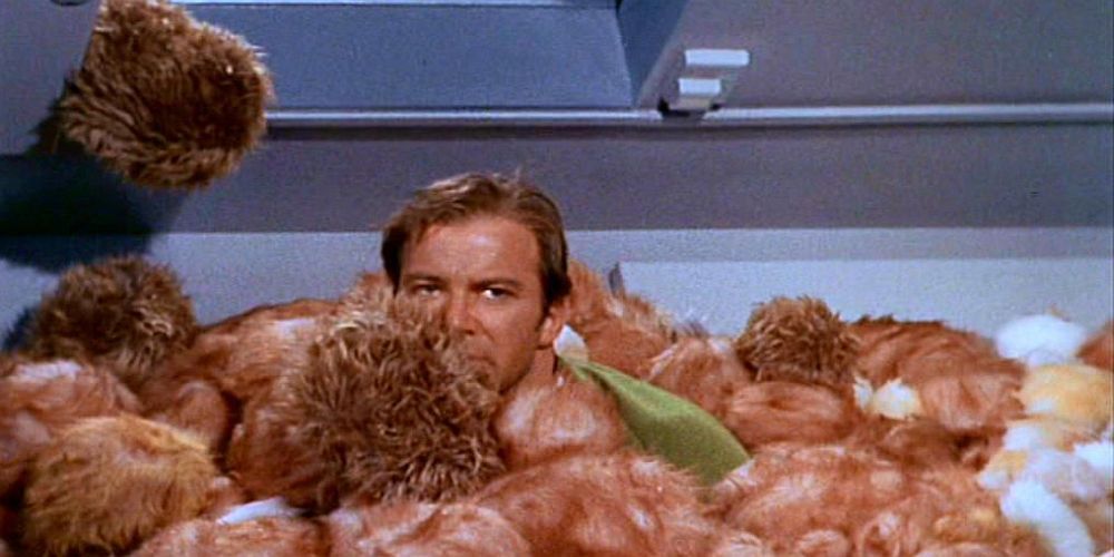 Captain Kirk reluctantly buried in a pile of tribbles in Star Trek: The Original Series