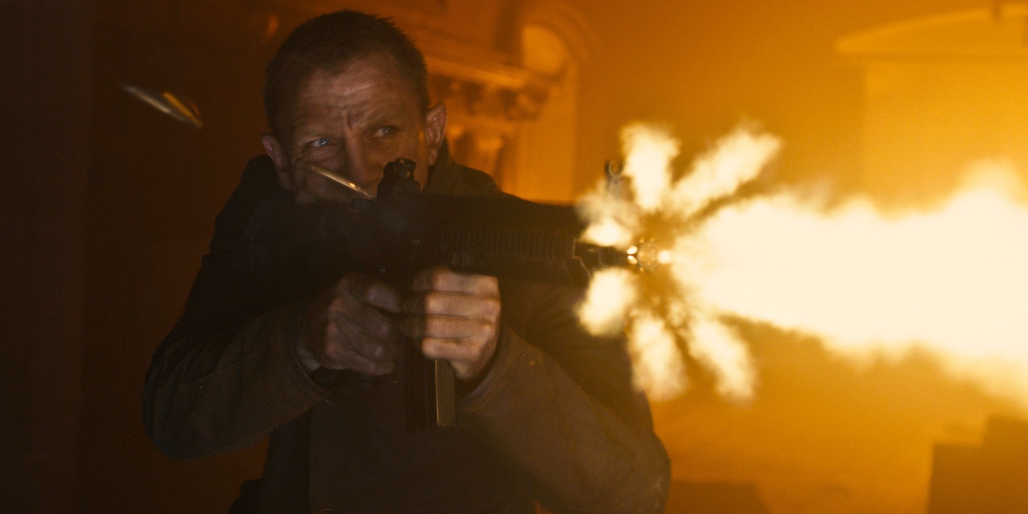 Daniel Craig as James Bond firing a machine gun in Skyfall