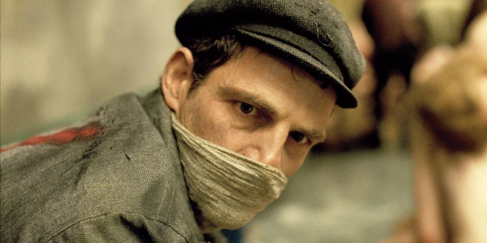 Saul covering his nose and mouth in Son of Saul