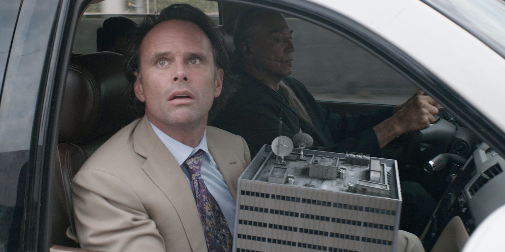 Walton Goggins as Sonny Burch holding a shrunken lab in Ant-Man and the Wasp