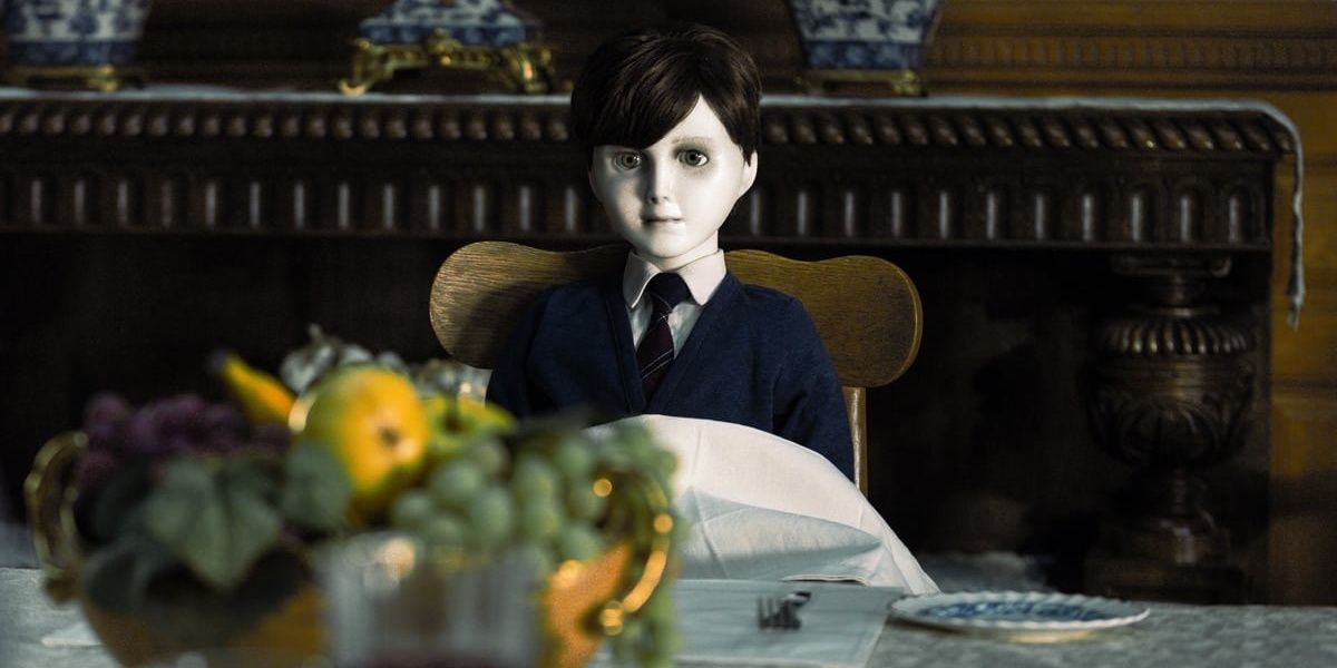 Brahms the doll sitting on a chair in The Boy, a 2016 horror movie
