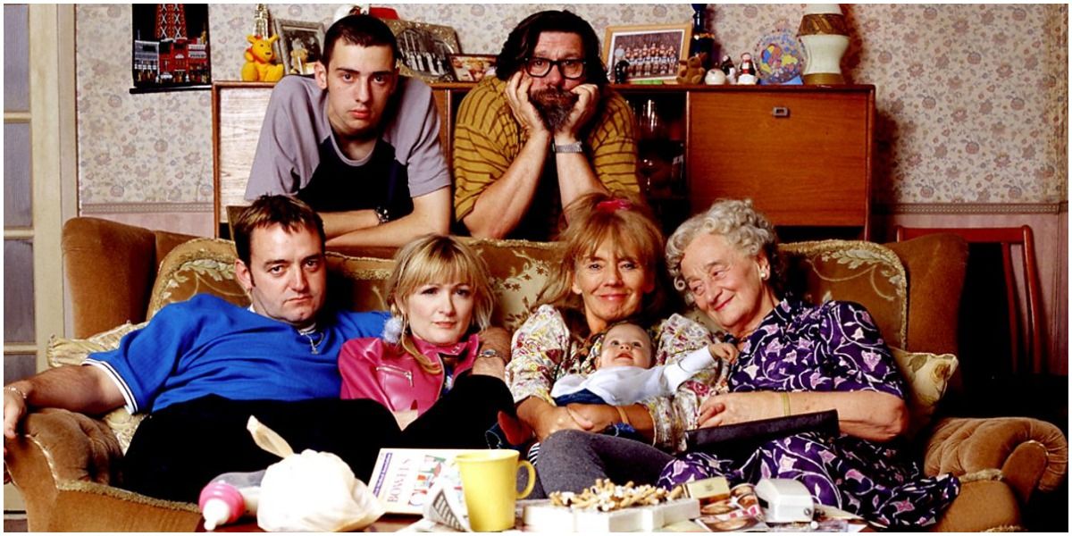 The Royle Family sits on and around the couch.