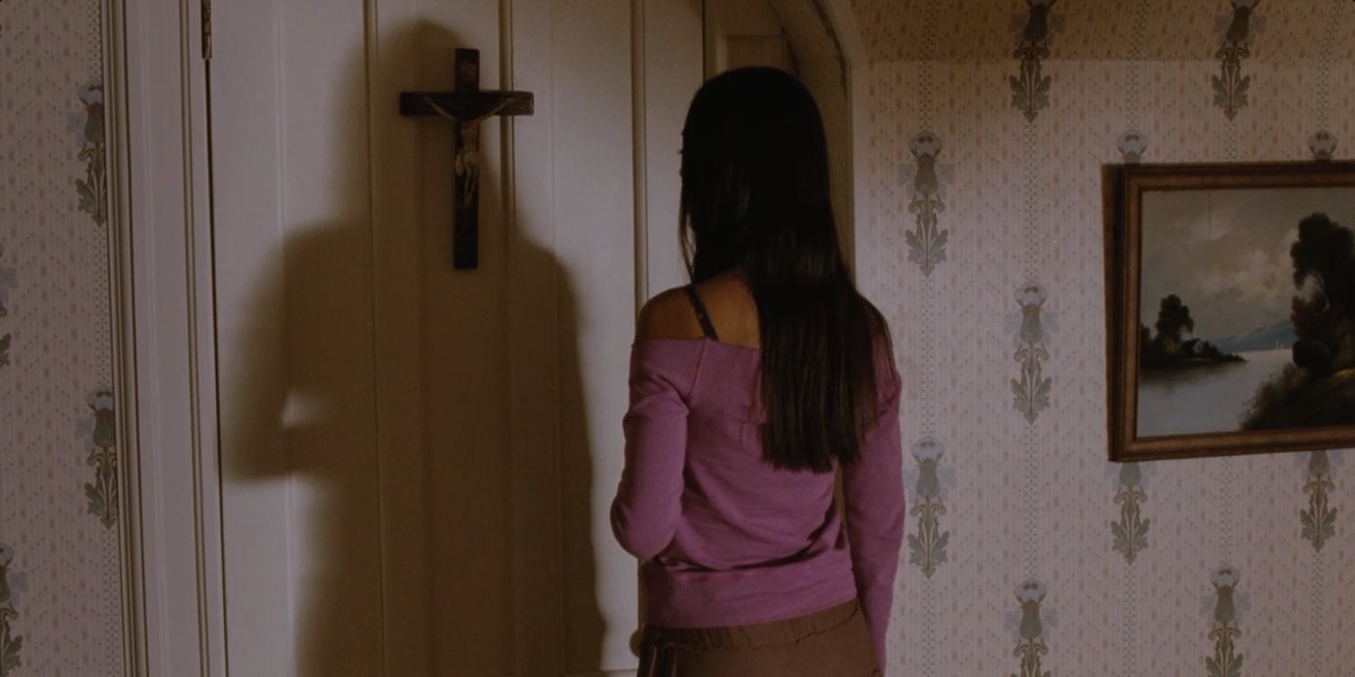 A character looking at a crucifix on a wall
