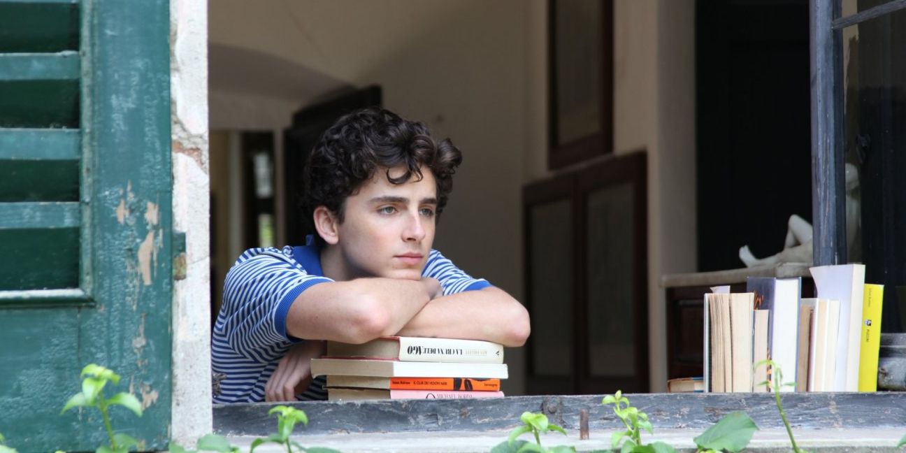 Elio rests his head on a pile of books in Call Me By Your Name