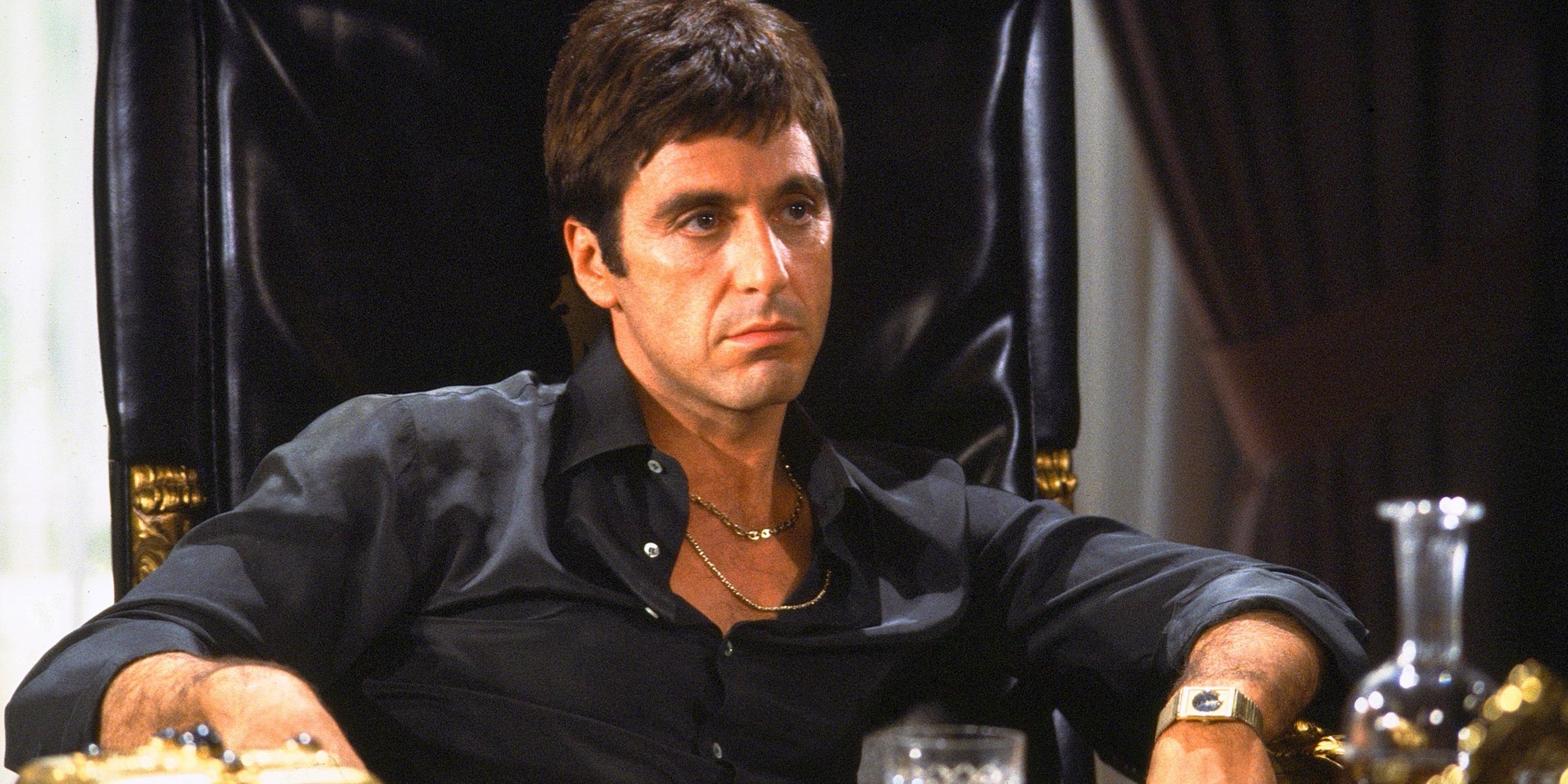 Tony Montana sitting behind his desk in Scarace