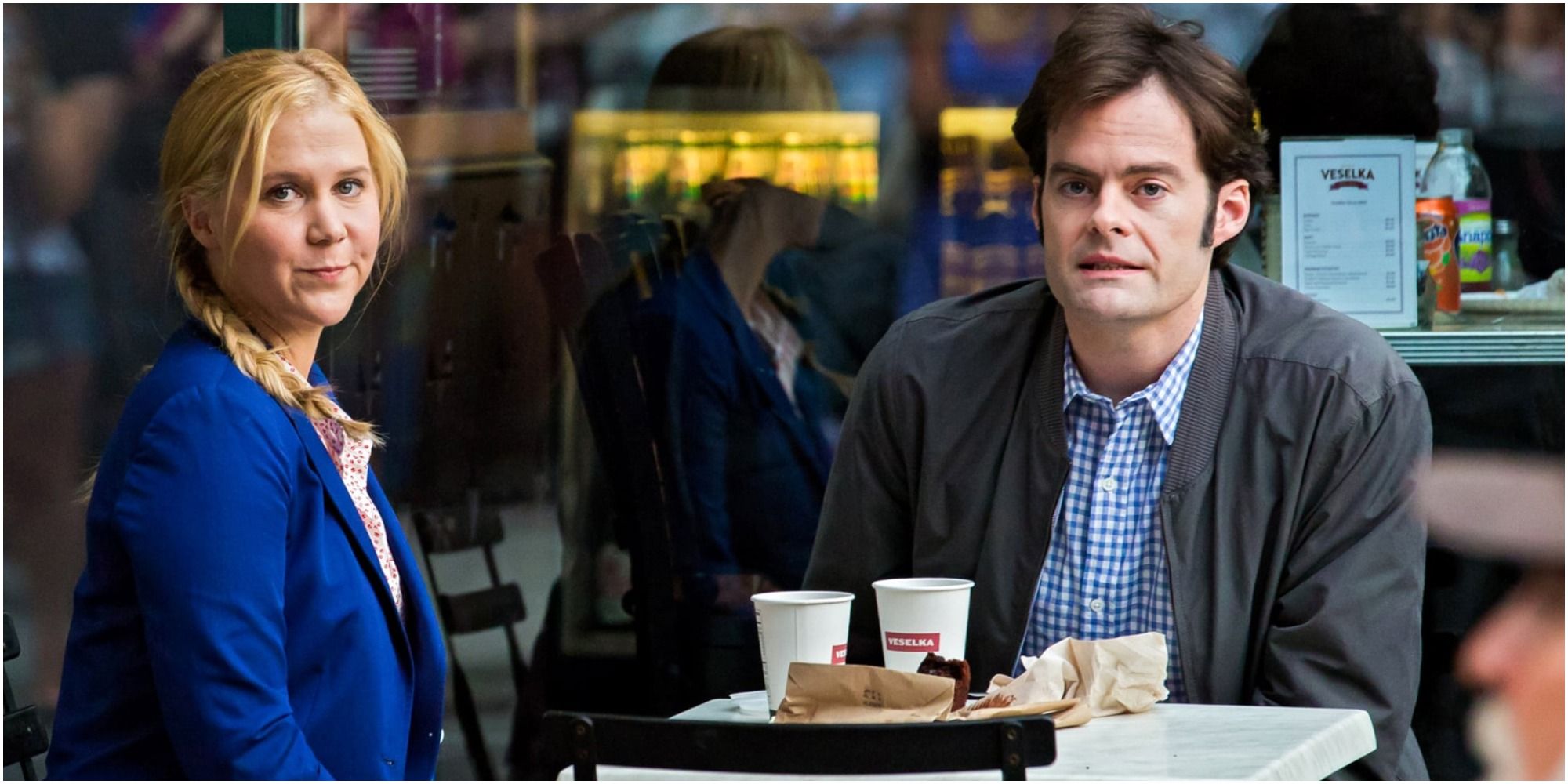 Bill Hader and Amy Schumer together at a table in Trainwreck