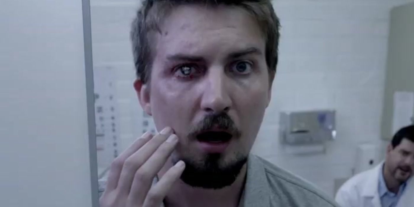 Herman looking at his eye implant in the mirror in V/H/S/2