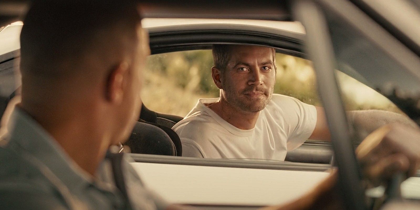 Dom and Brian look at each in cars in Furious 7