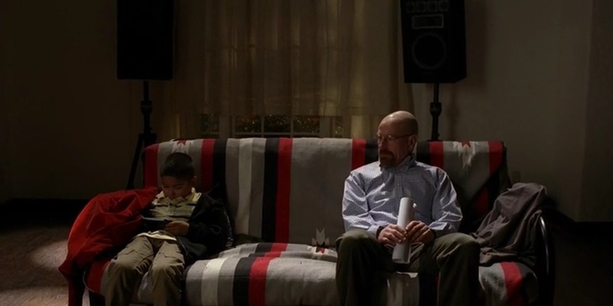 Walt and Brock sit on a couch in Breaking Bad