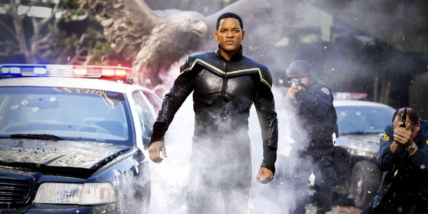 Hancock in his superhero suit walking past a crashed police car