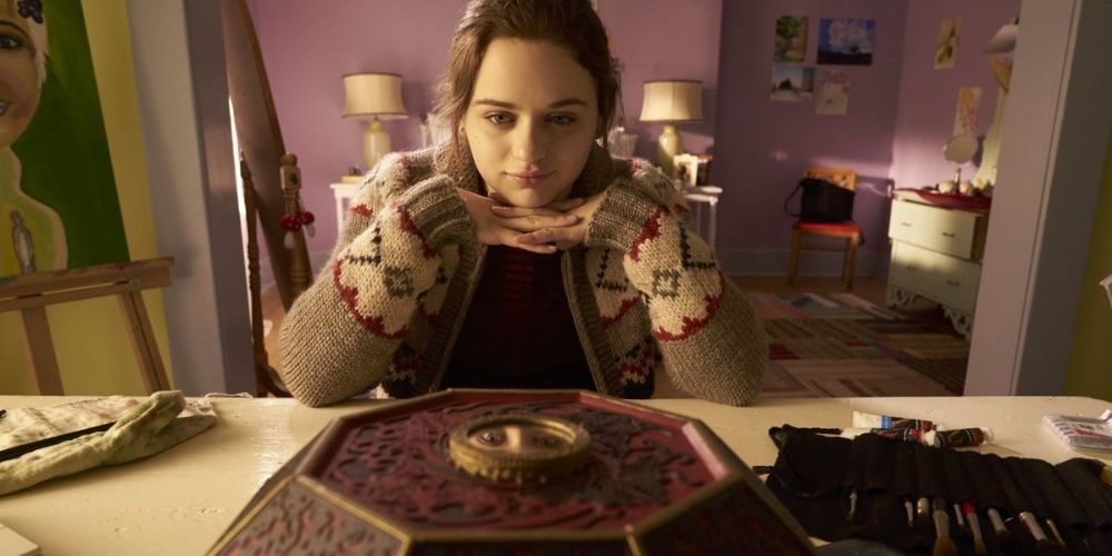 Joey King looking at the box in Wish Upon