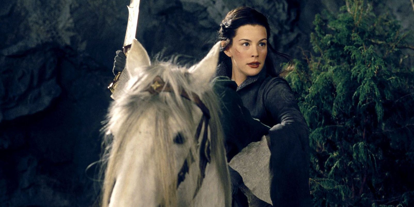 Arwen holding up her sword on the back of her horse with a hunched Frodo in front of her in Fellowship of the Ring. 