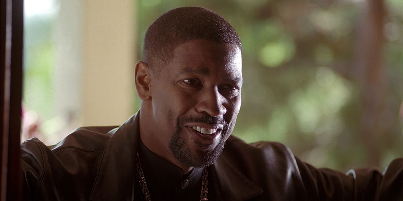 Denzel Washington standing in doorway, smiling, in Training Day