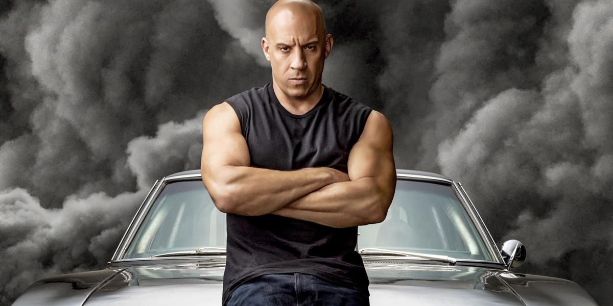 Dominic Toretto stands in front of his car