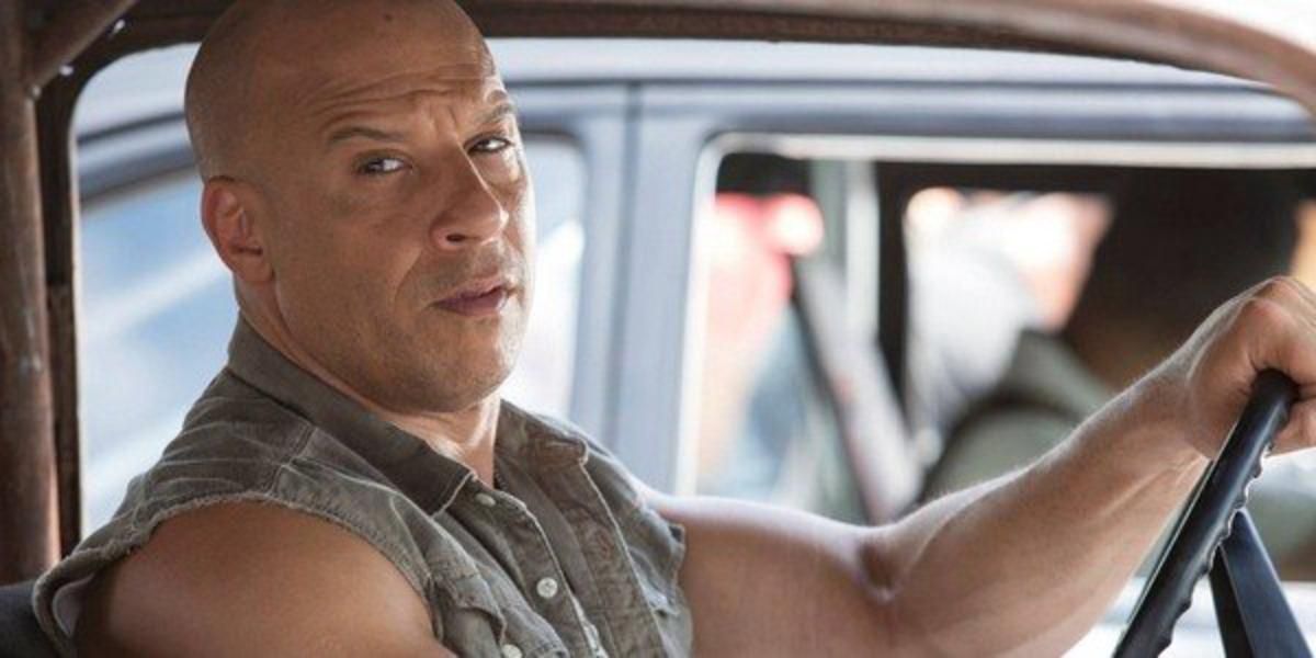 Dominic Toretto drives a car and looks to his side