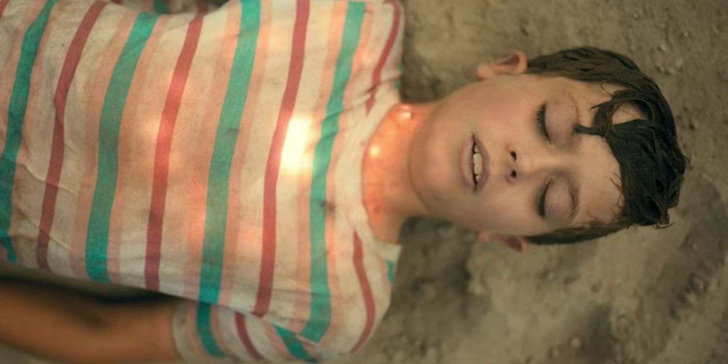 A young Harlan (Justin Paul Kelly) glowing and lying on a beach in The Umbrella Academy