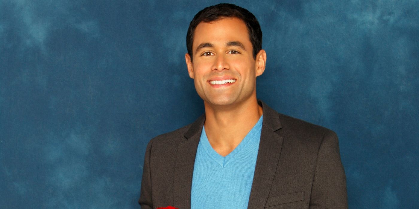 jason mesnick smiling and holding a red rose