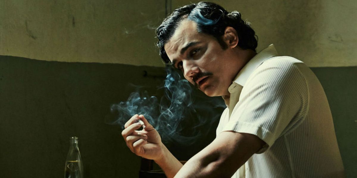 Pablo Escobar holding a cigarette in Narcos.