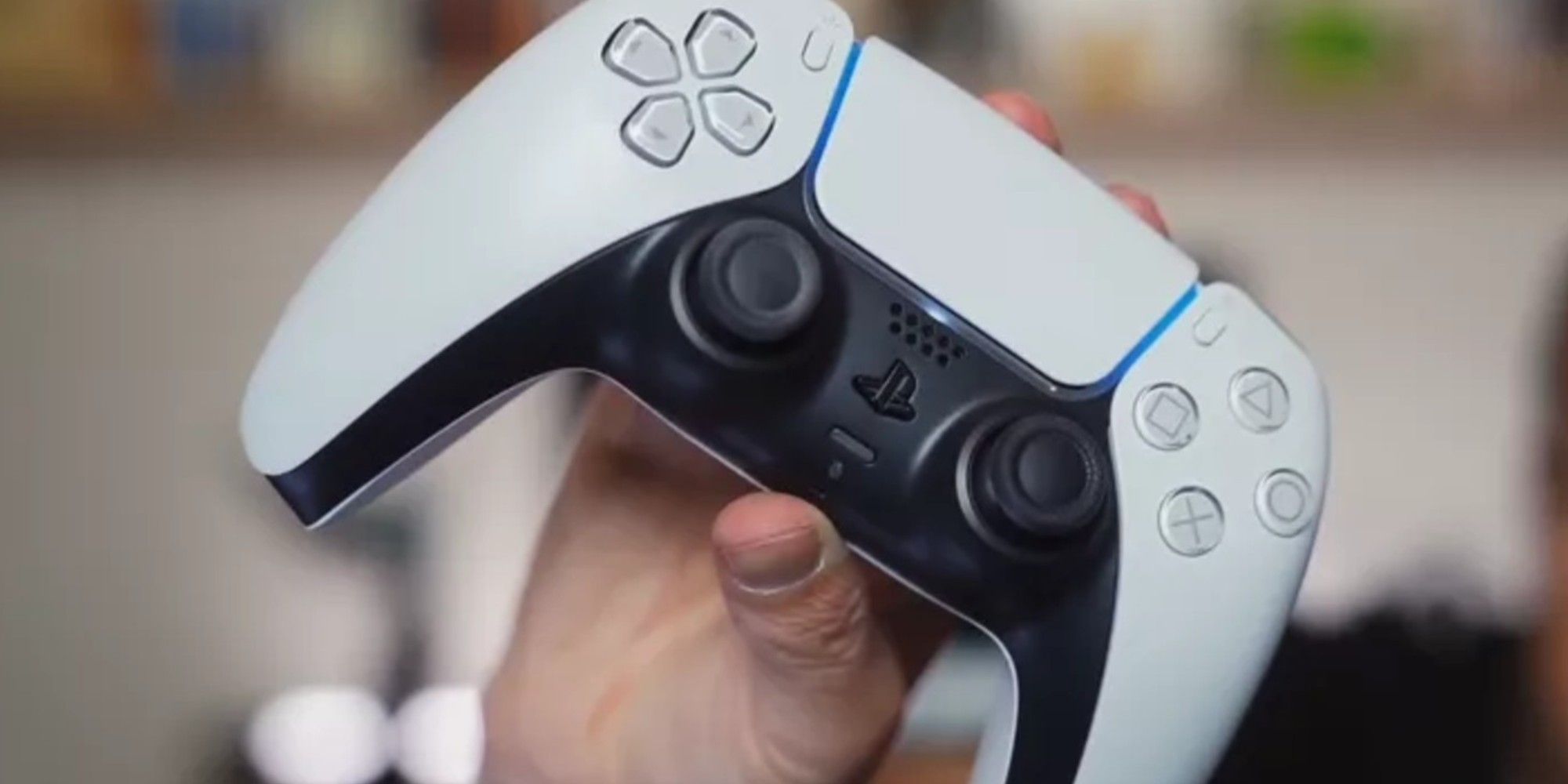 PS5 controller being held in a person's hand 