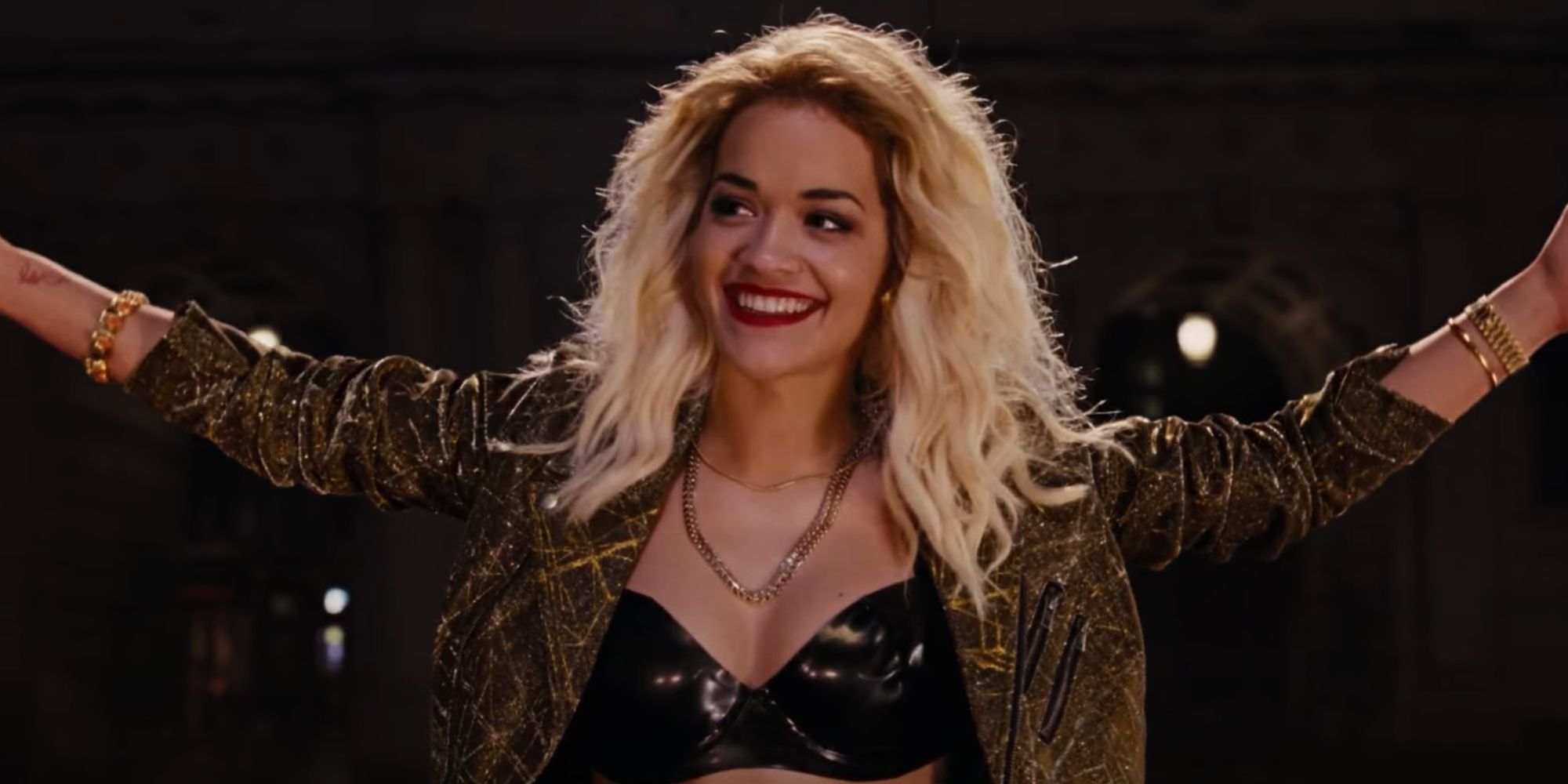 Rita Ora standing with her arms raised in Fast and Furious 6 
