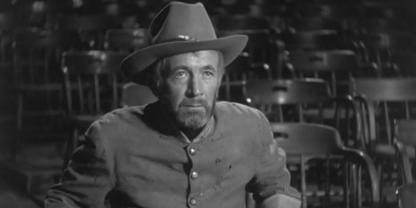 Walter Brennan in cowboy hat, sitting in chair in The Westerner