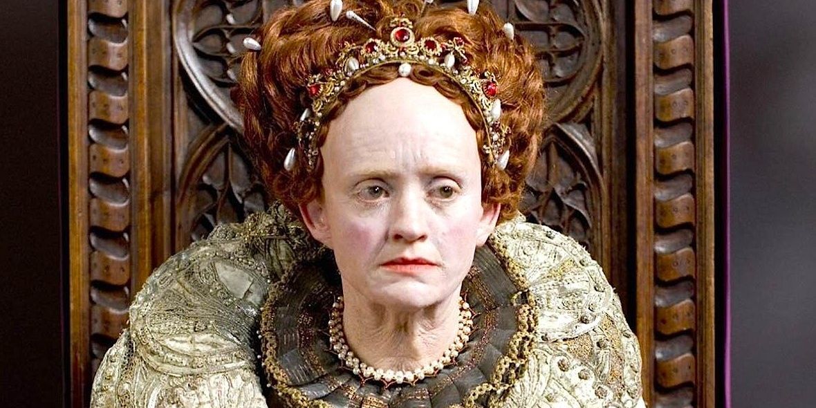 Anne-Marie Duff as Elizabeth on the throne in grotesque makeup