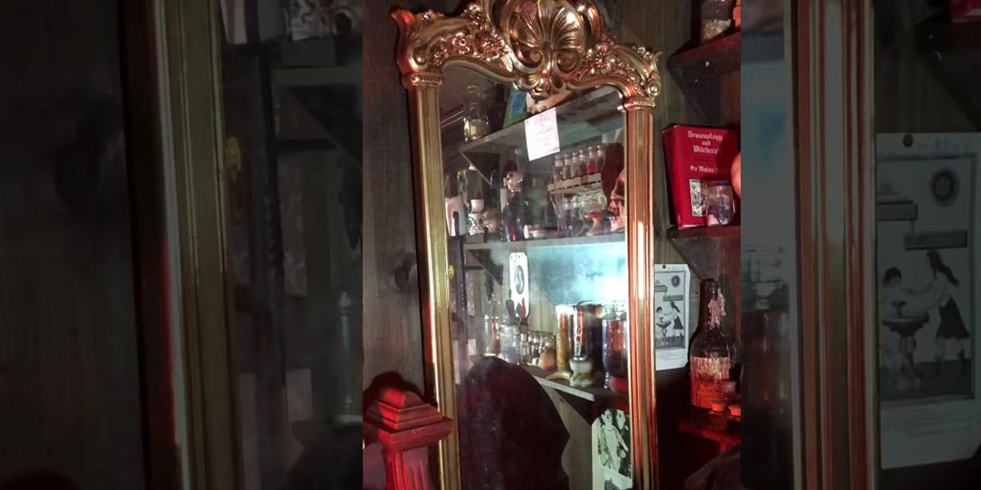 The Conjuring mirror reflecting the shelves in the Warren occult museum