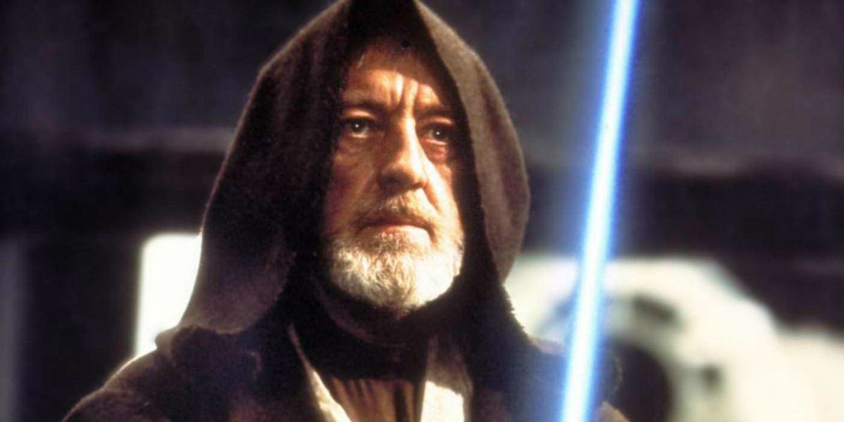 Alec Guinness as Ben Kenobi wielding his lightsaber in Star Wars