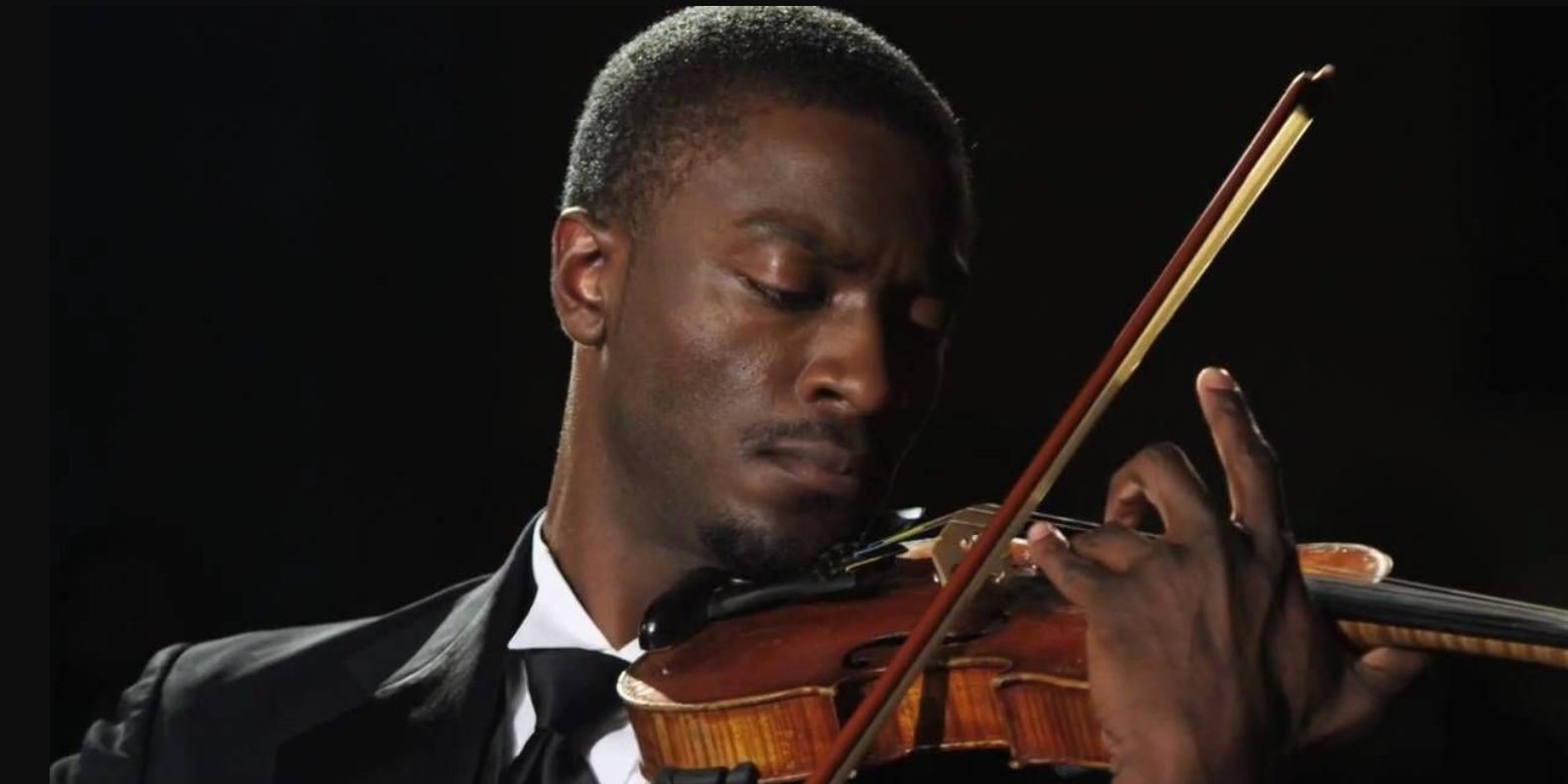 Alec Hardison In Leverage playing a violin