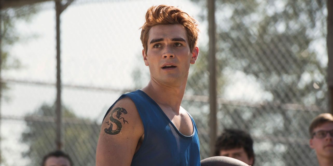 Archie in a tank top, staring off to the side of the camera in Riverdale