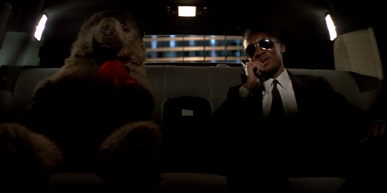 Argyle in Die Hard in the back of a car with a teddy bear.