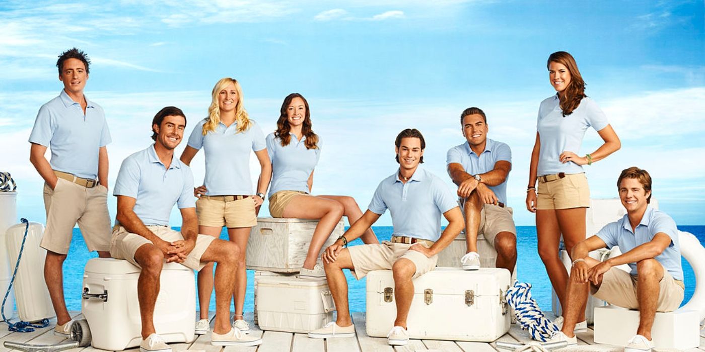 Below Deck season 2 cast promo photo cast sitting on trunks, wearing uniforms