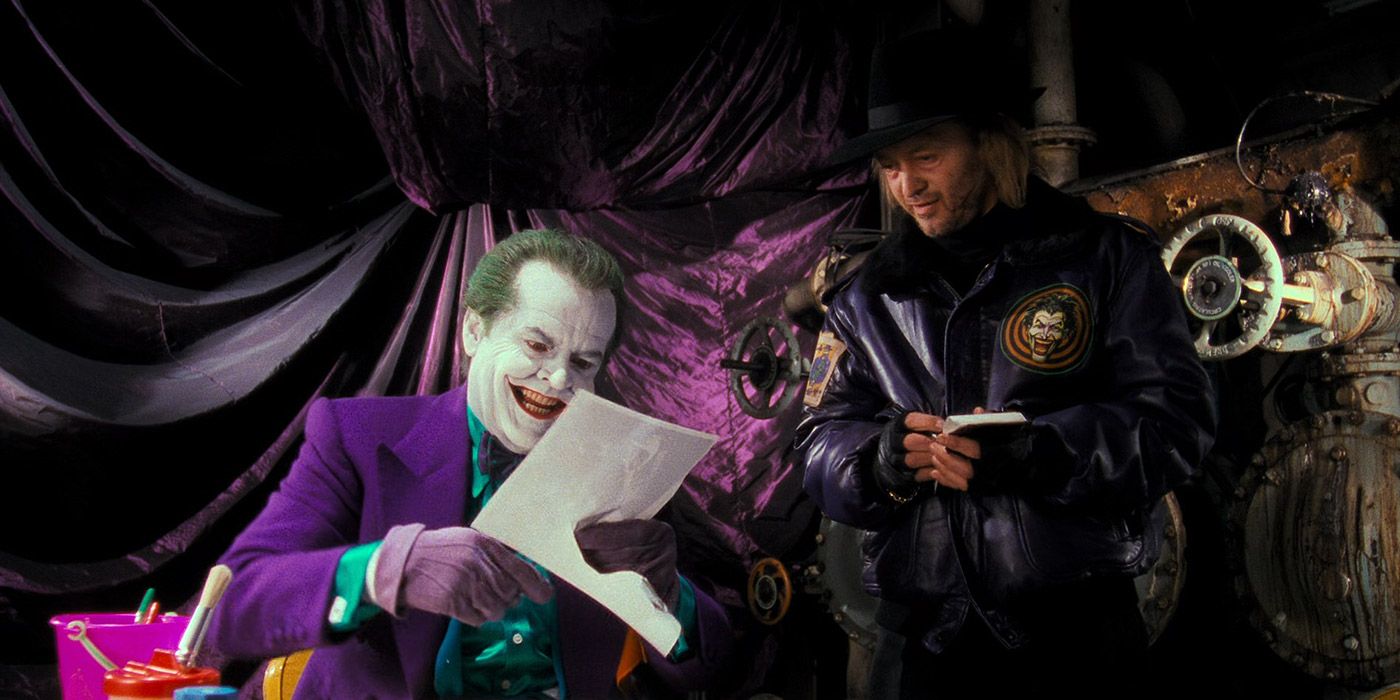 The Joker cutting out a picture in Batman