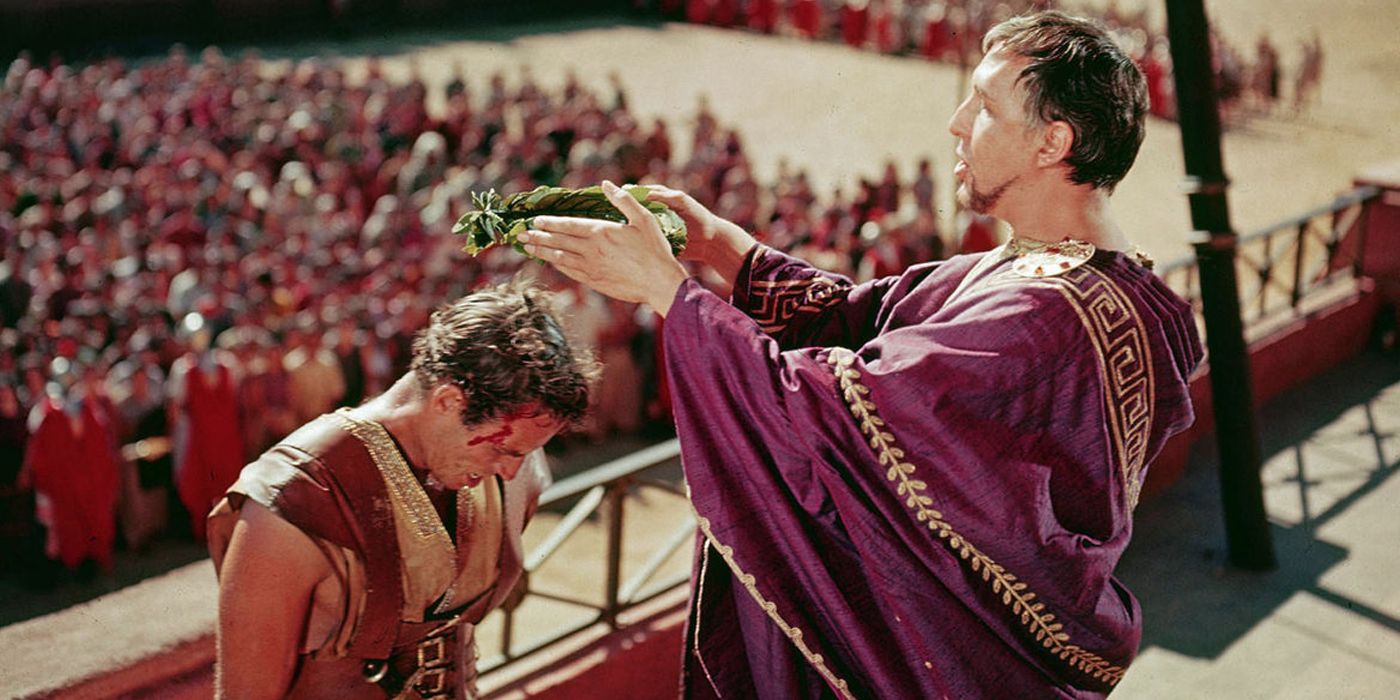 An emperor places a crown of olive leaves on Ben-Hur's head