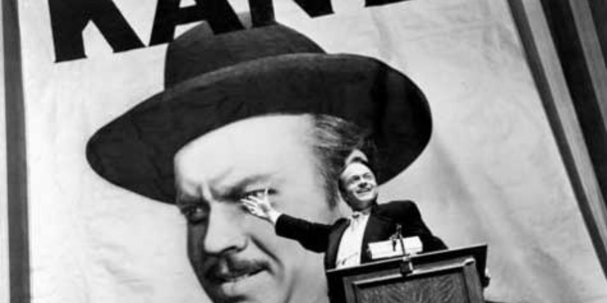 Citizen Kane speaking in front of a poster of himself