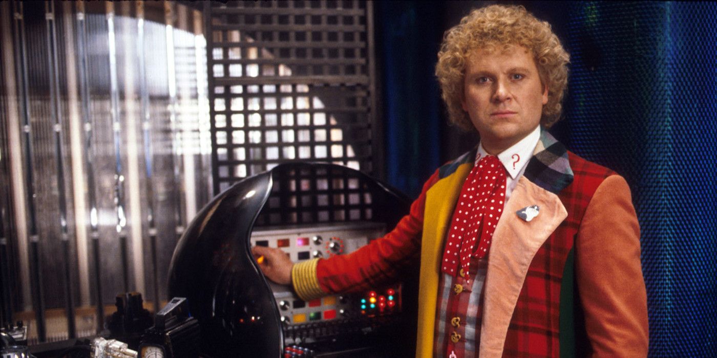 The Sixth Doctor stands next to the Tardis controls in Doctor Who