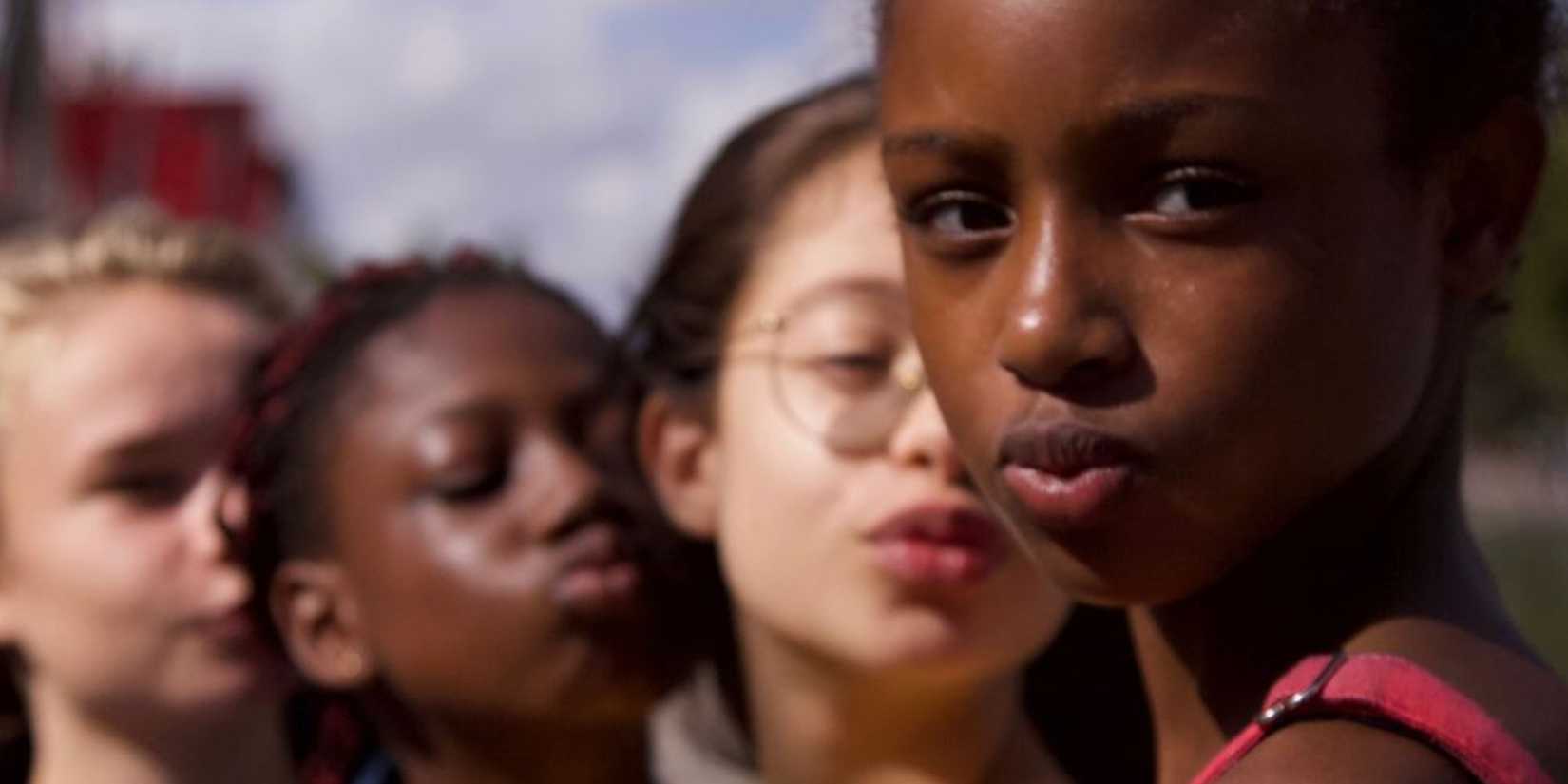 four girls (one of whom is looking at the camera) from the Netflix movie Cuties