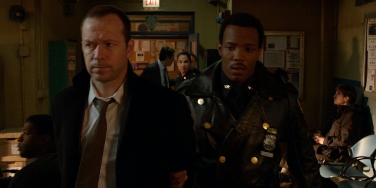 Danny being escorted through his precinct after his arrest in Framed Blue Bloods